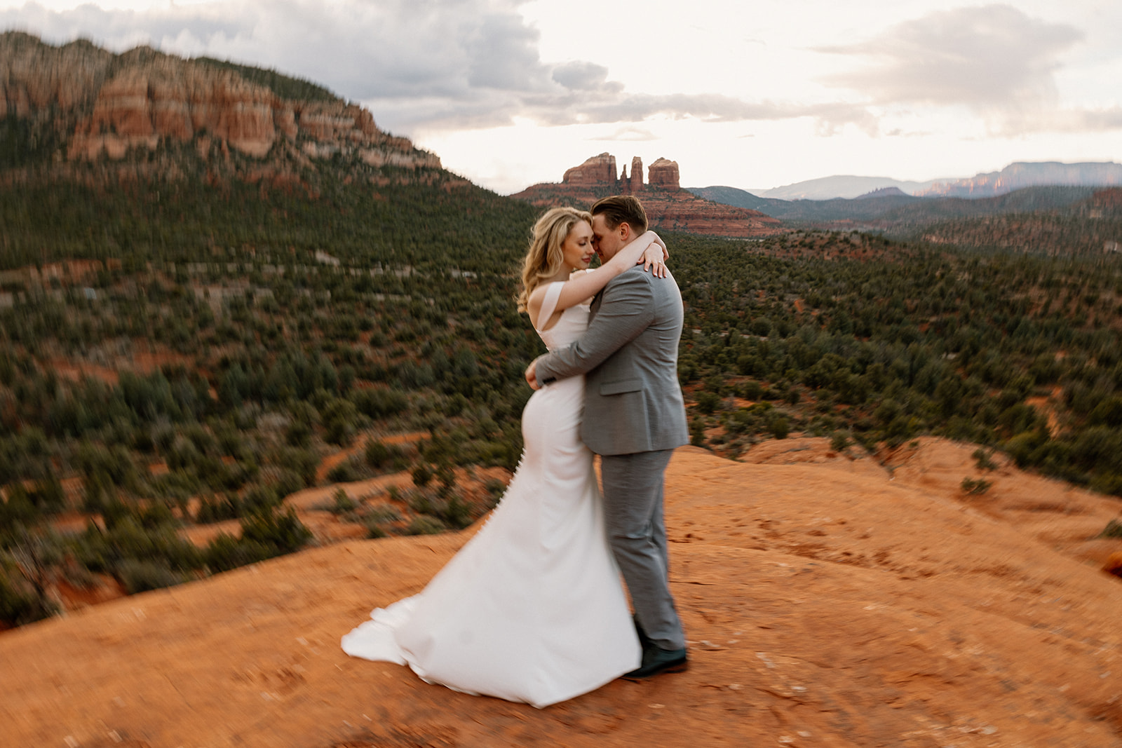 Bride and groom embracing during private first dance after Sedona elopement