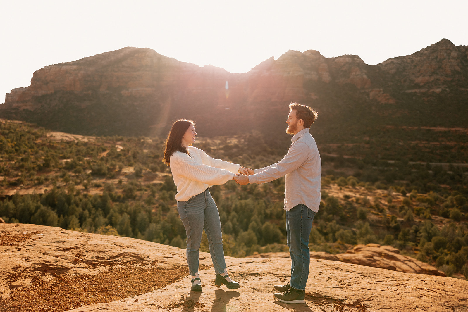 Couple dances together during Sedona elopement photos on top of red rock cliffs