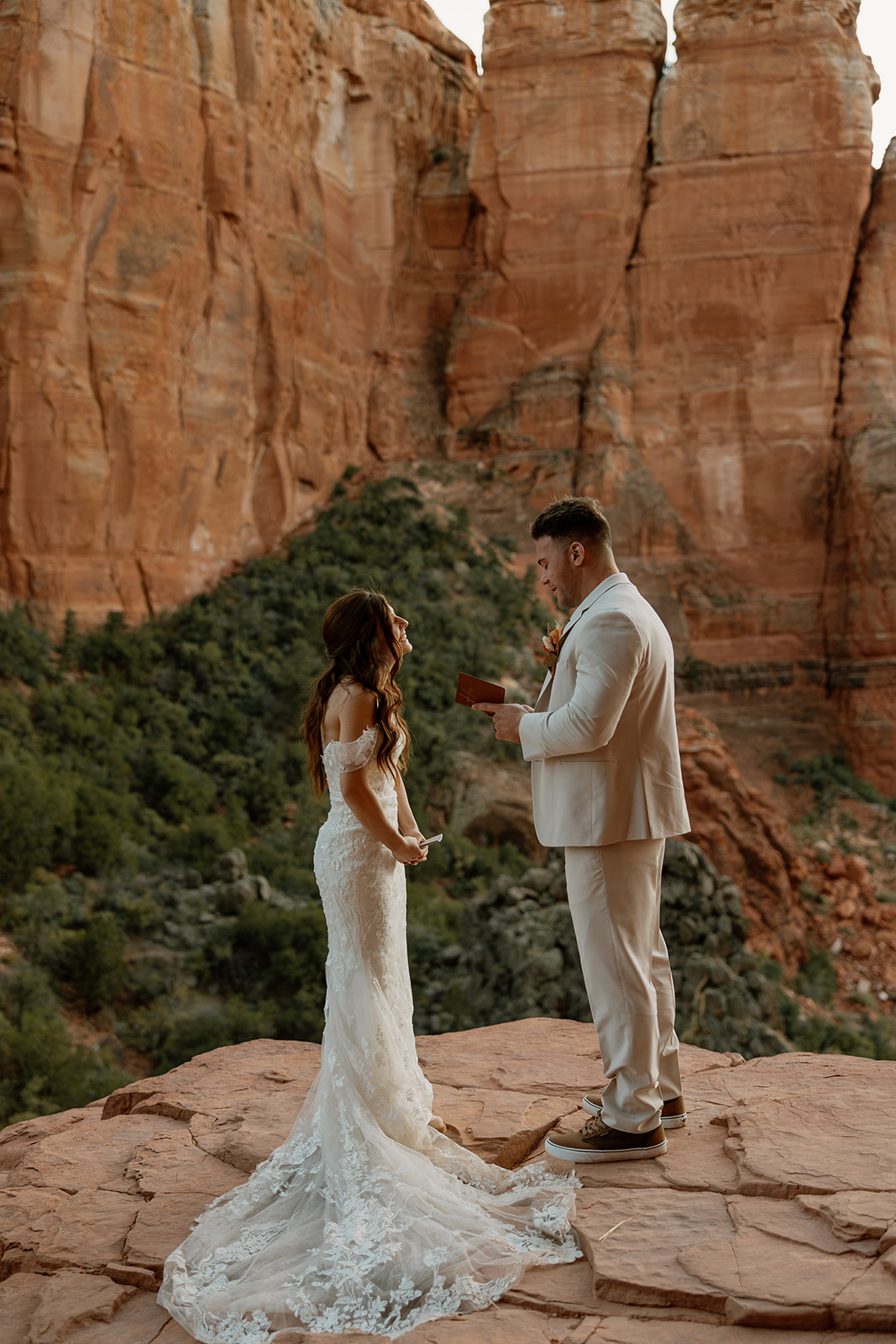 Groom reading vows to bride privately before Sedona elopement ceremony