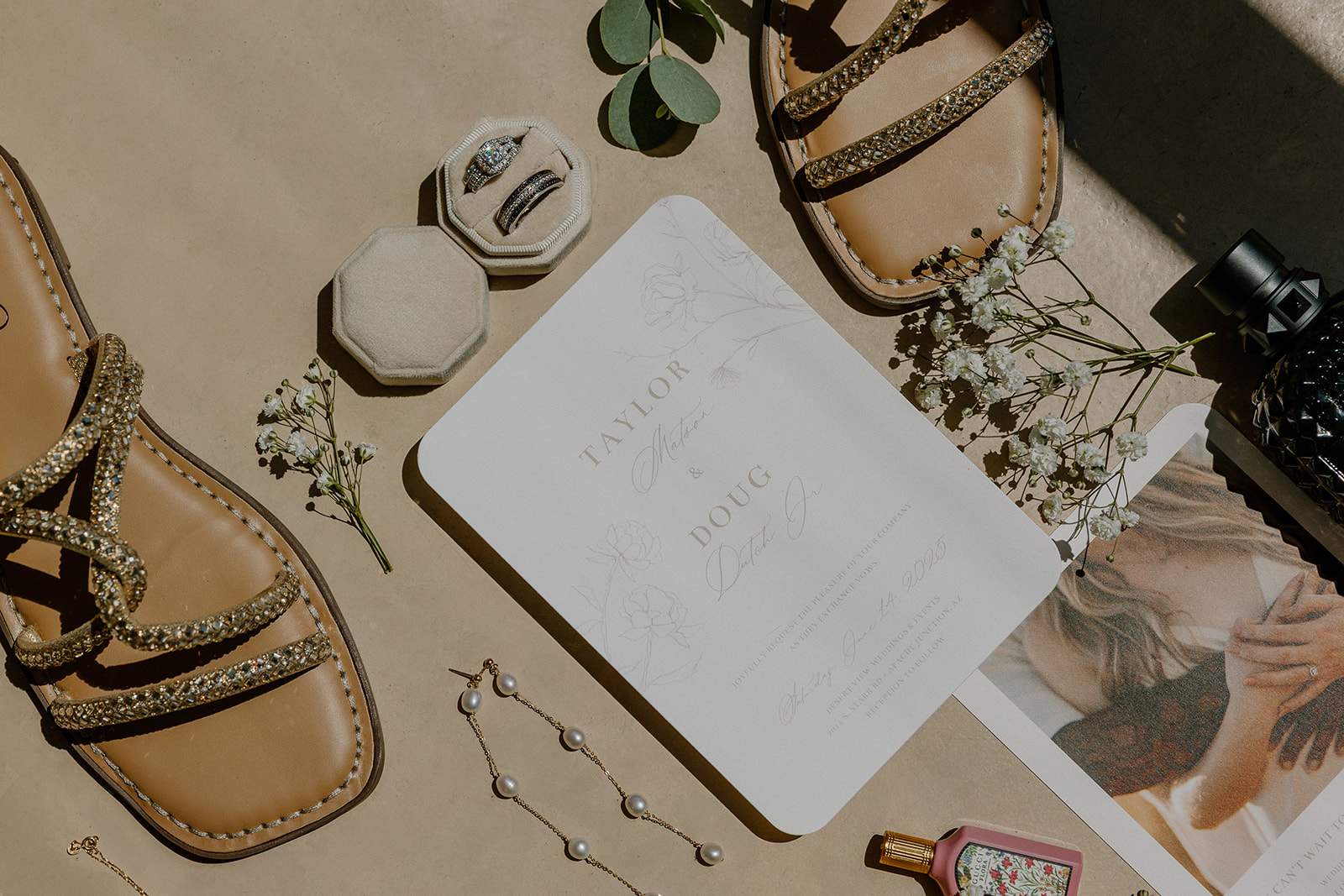 Wedding flatlay with bride's shoes, jewelry and wedding invitation from their Desert View weddings