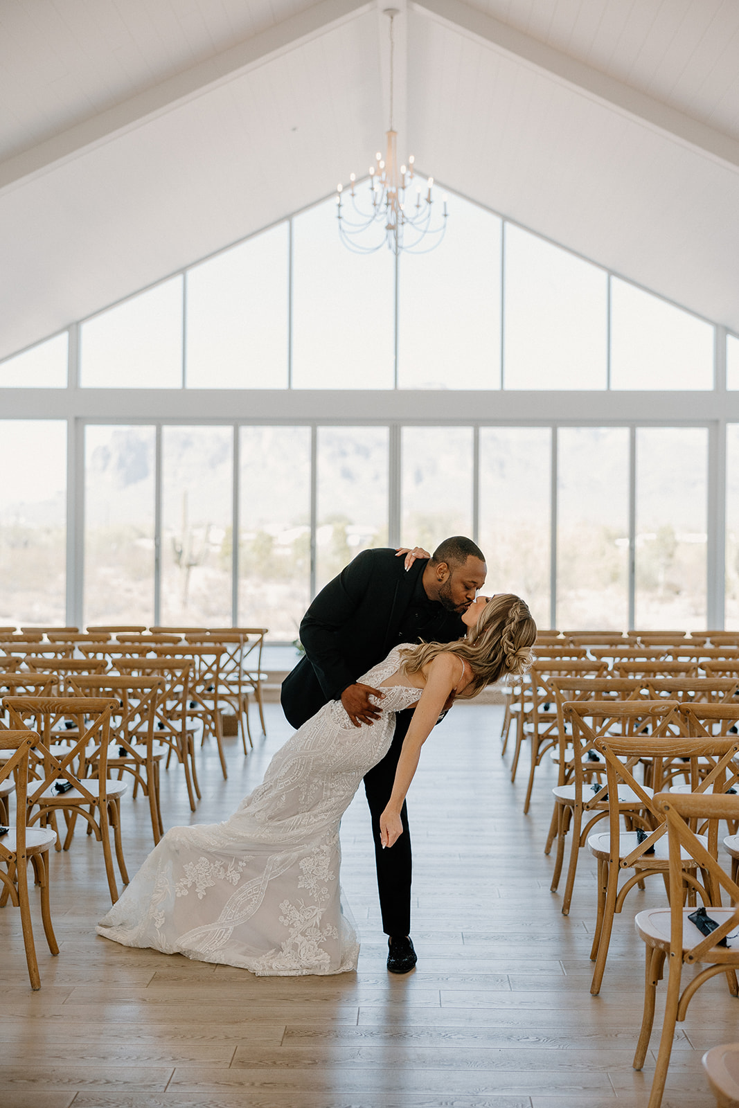 A wedding ceremony taking place in a wedding venue by the beautiful Arizona landscape, adorned with flowers and elegant decorations.