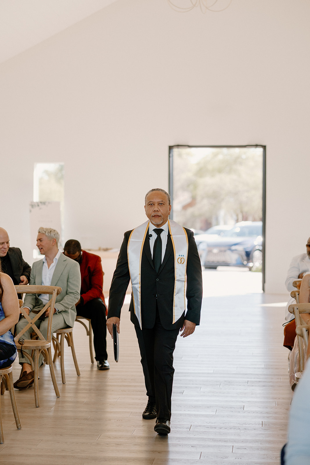 The wedding officiant walks confidently down the aisle, ready to lead a heartfelt desert view weddings ceremony.