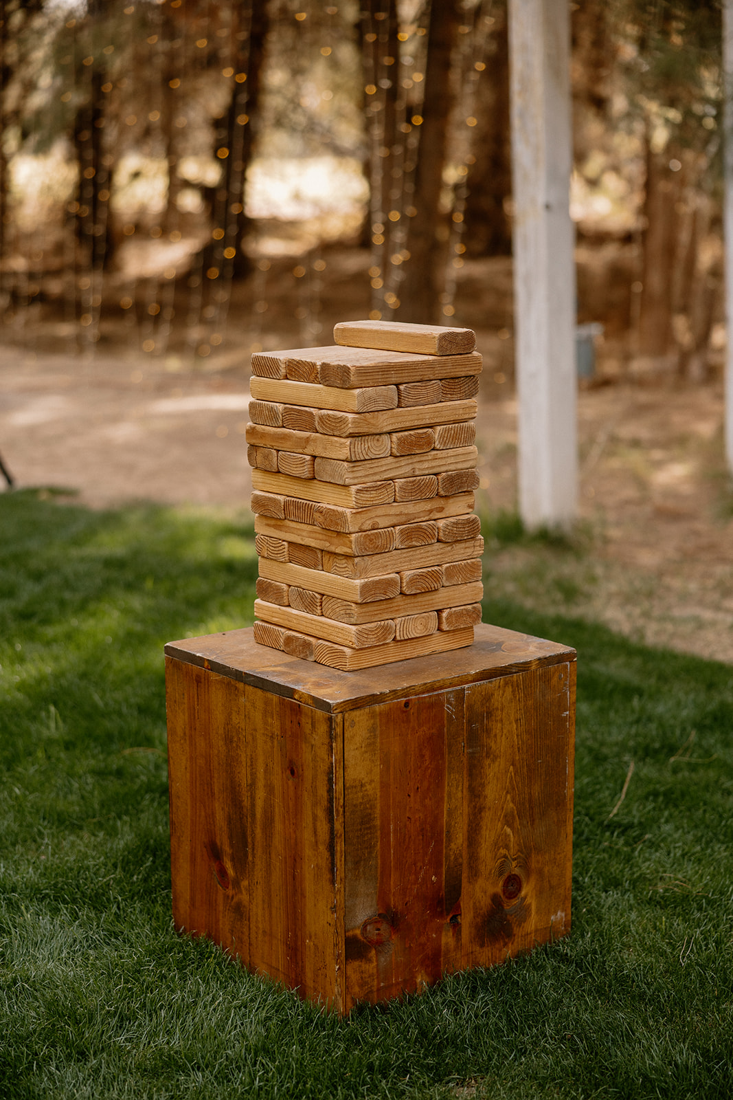 Life size outdoor jenga game set up on wooden table for outdoor wedding reception at Schnepf Farms