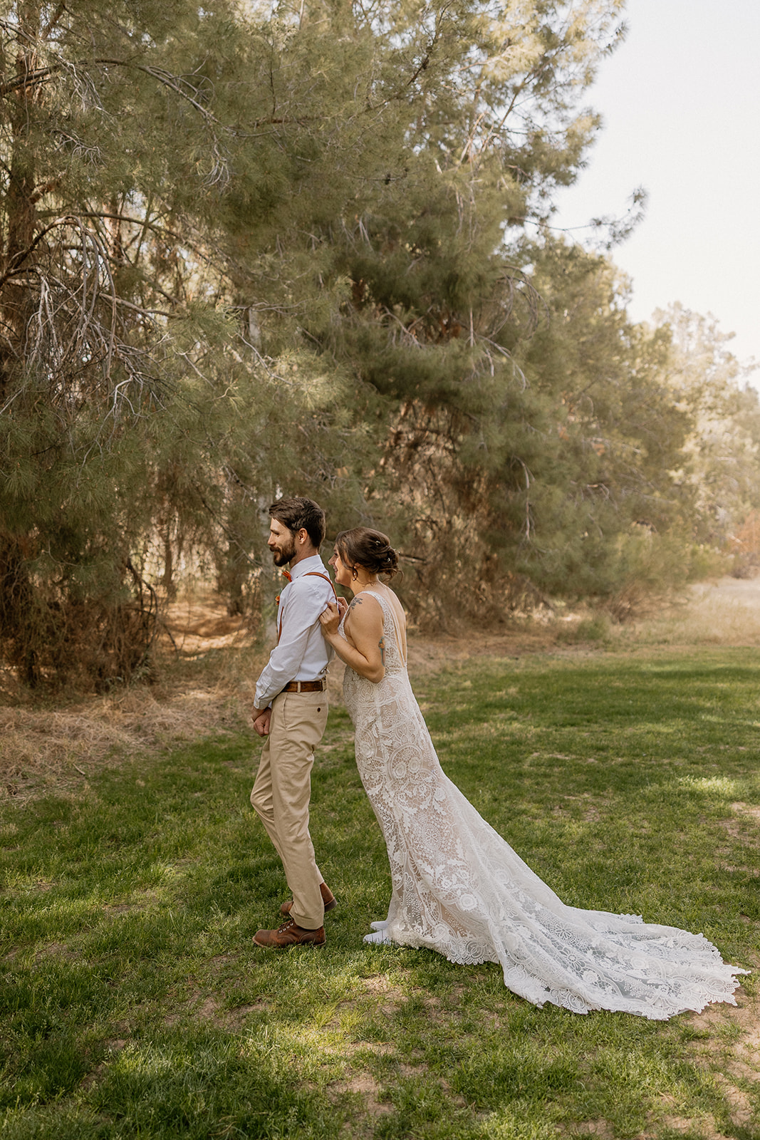 Bride quietly approaches her groom from behind for their emotional first look moment at Schnepf Farms.