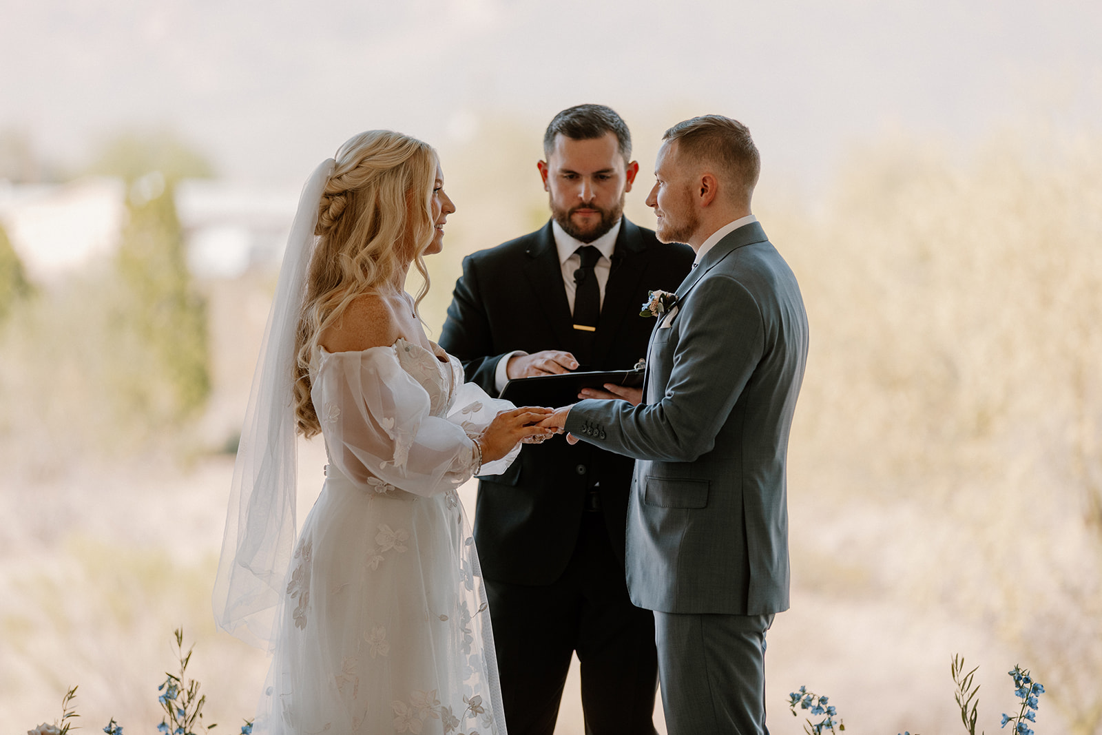 Couple holds hands and looks at one another during emotional wedding ceremony at Desert View wedding 