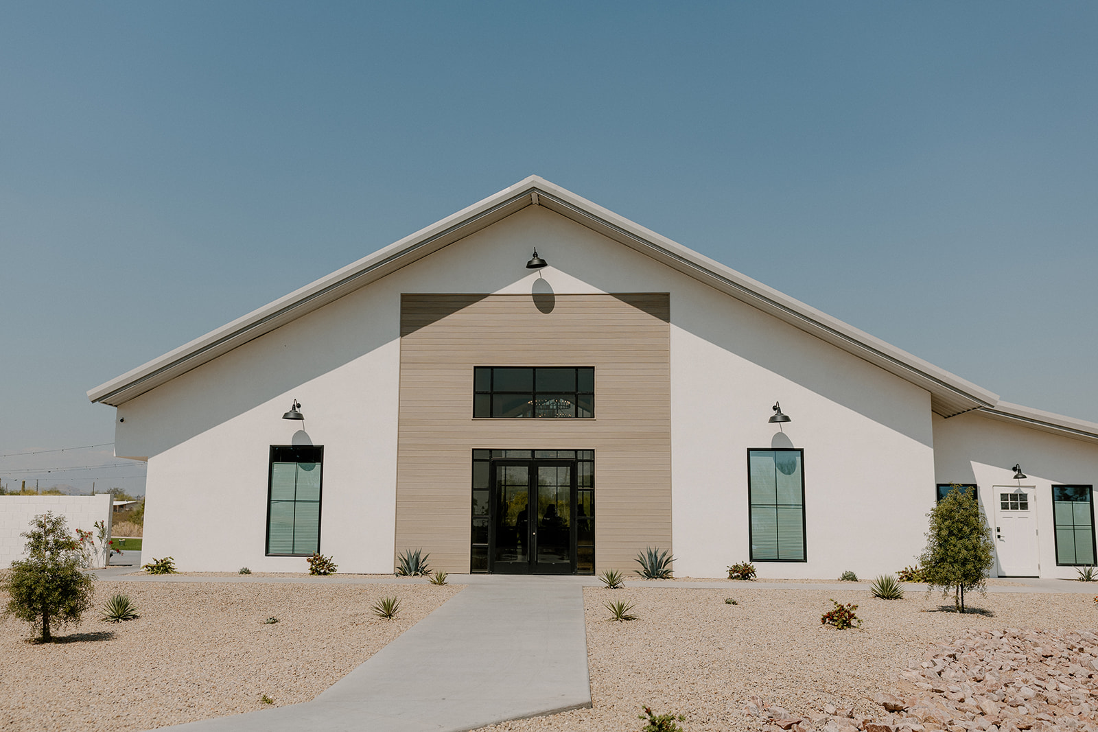 Modern structure of outside of Desert View Weddings & Events. Beautiful and clean white building in the desert. 