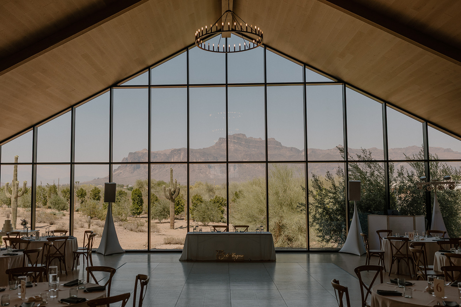 Inside Desert View Weddings & Events looking out at the beautiful desert landscape through tall windows. 