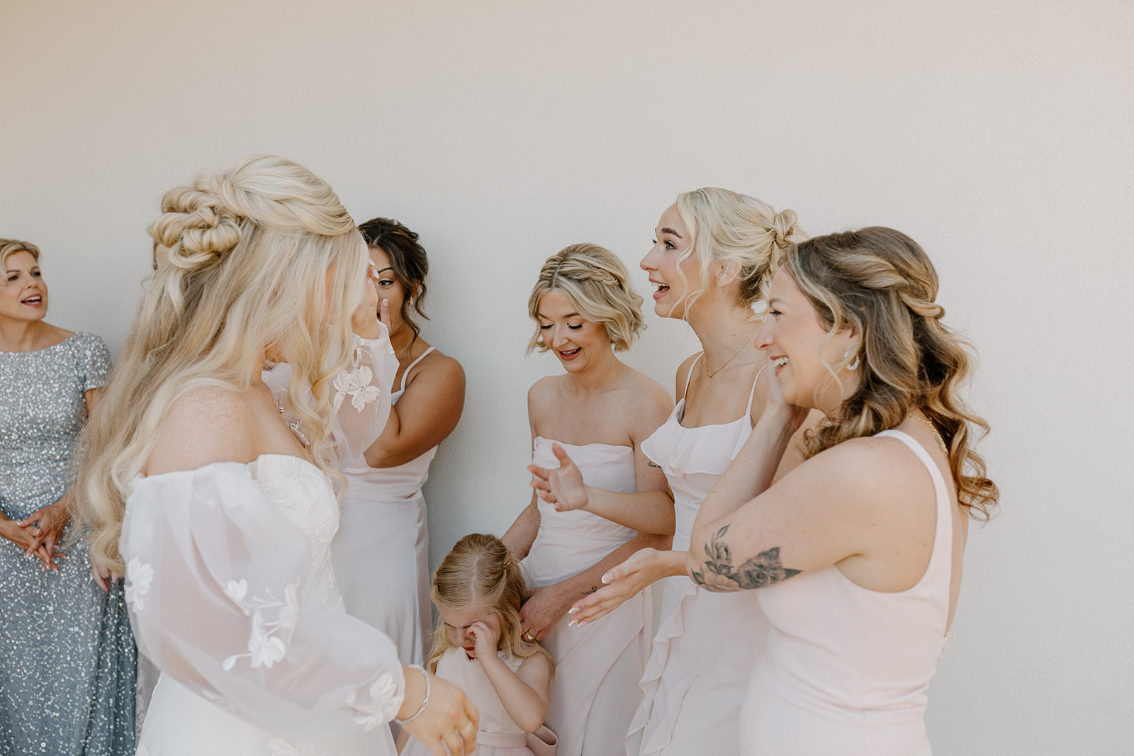 Bride and bridesmaids get emotional as they see the bride all dressed and ready for her big day. 