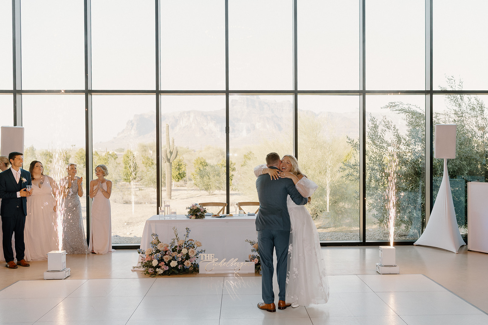 Bride embraces groom during first dance together at Desert View wedding. 