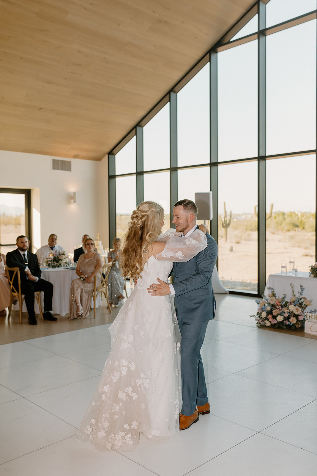 Couple dances slowly on dance floor as newly married husband and wife.