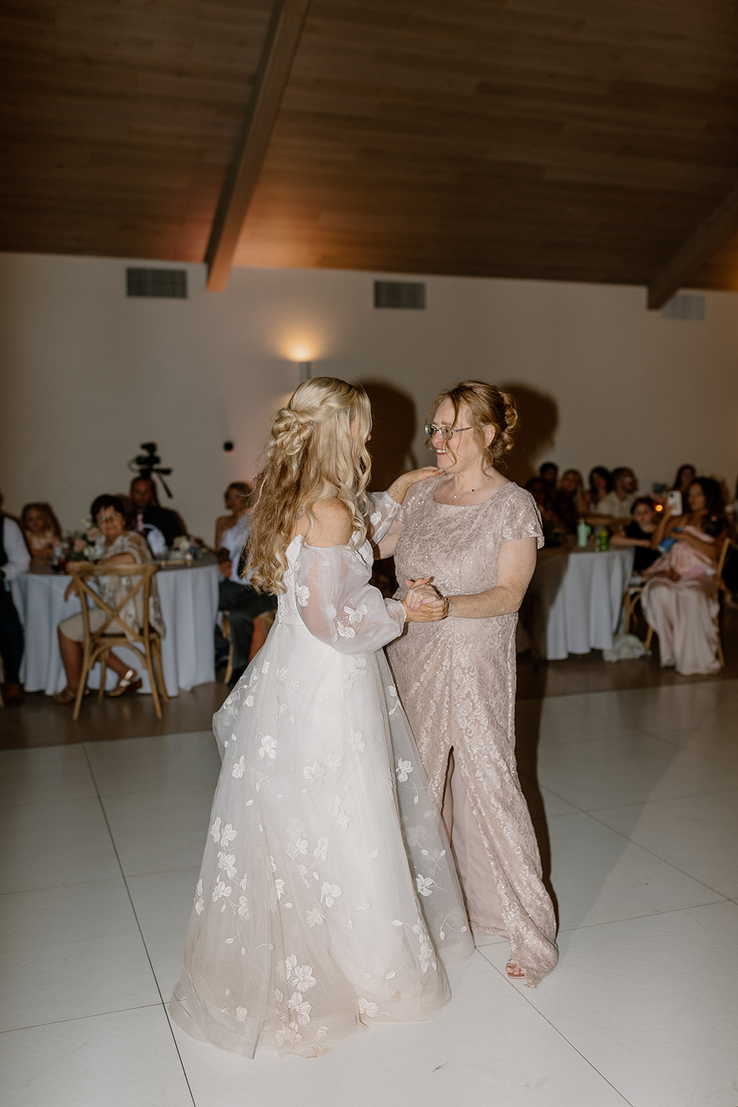Bride dances with her mother slowly to honor their relationship and bond. 