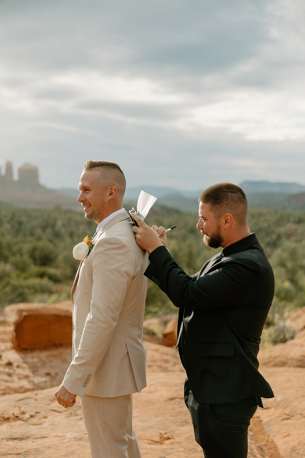 Officiant signs marriage license to make it all official after their Bell Rock Sedona elopement. 