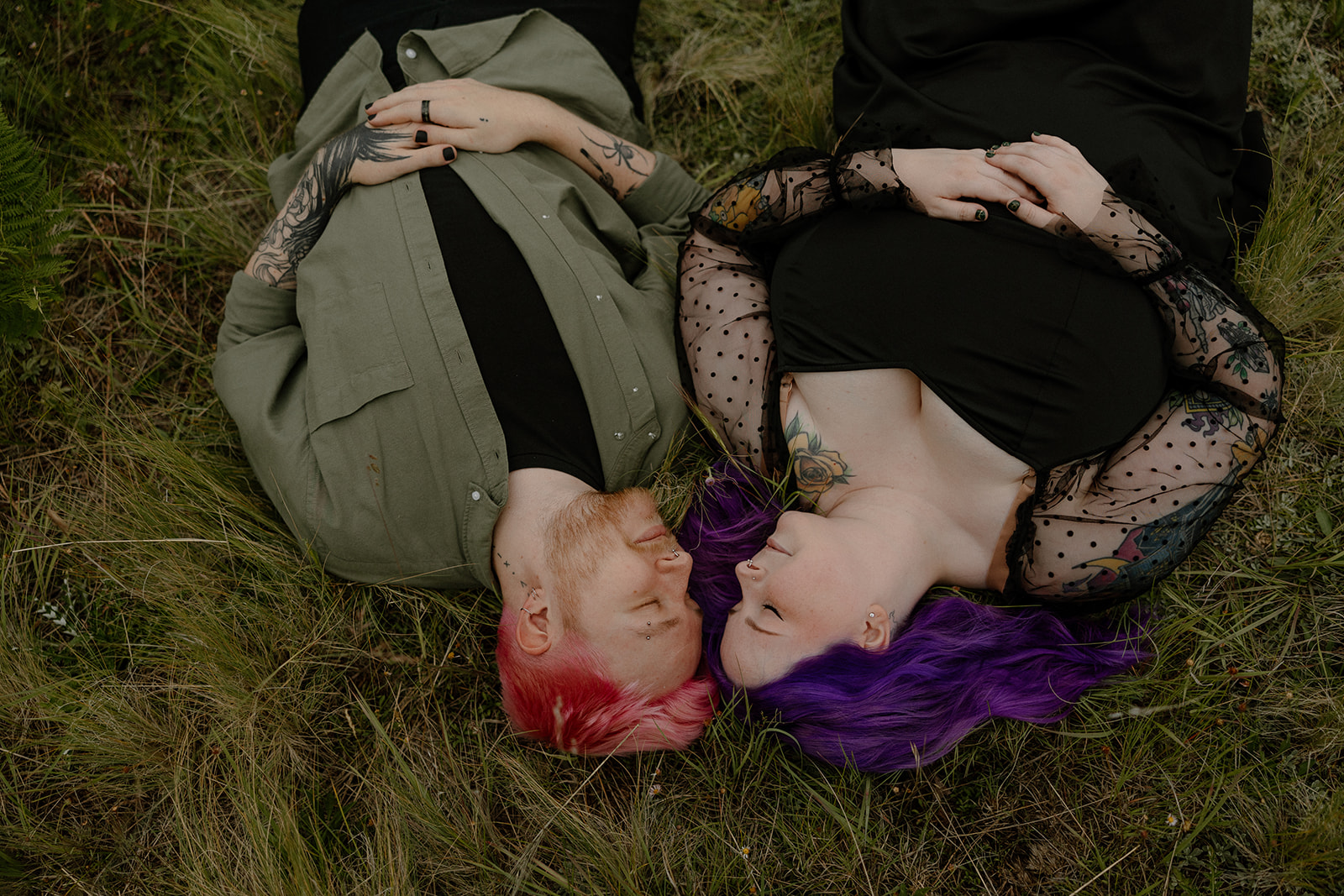 Engagement photo ideas don’t get more whimsical than this—couple laying in the grass face-to-face, colorful hair fanned out like a storybook.