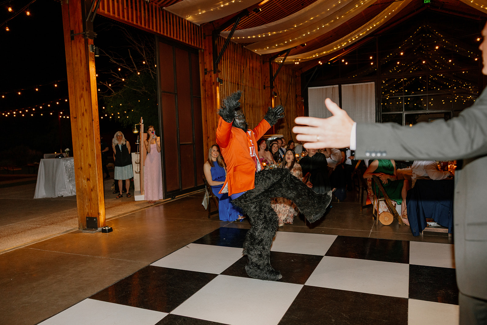 The Suns Gorilla entertains guests on the dance floor under string lights at one of the most fun-filled wedding venues in Arizona.