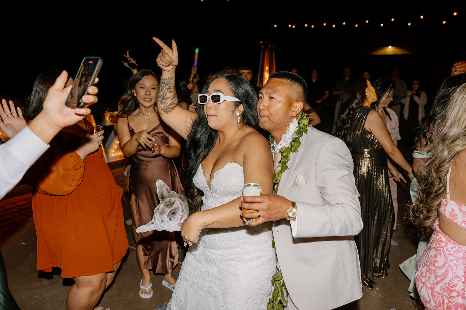 The Paseo wedding reception turns up as the bride and groom hit the dance floor—sunglasses on, drink in hand, surrounded by friends.