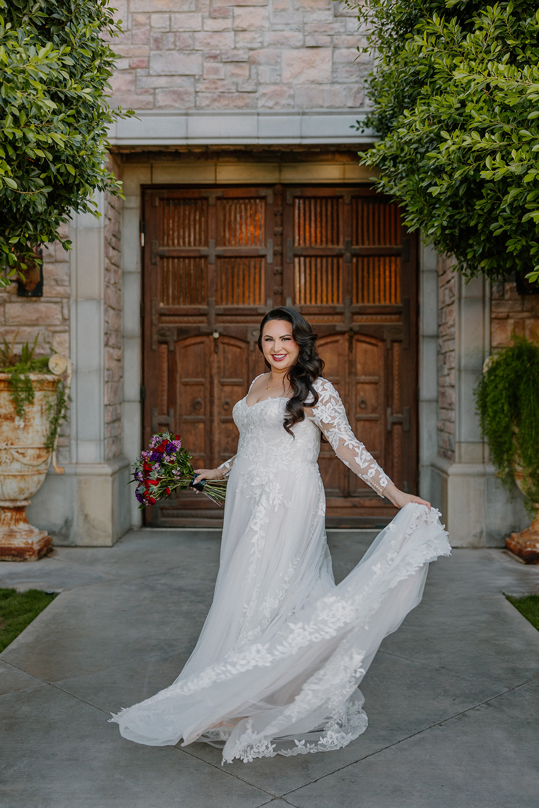 Bride twirling her lace gown in the courtyard of a wedding venue in Chandler.