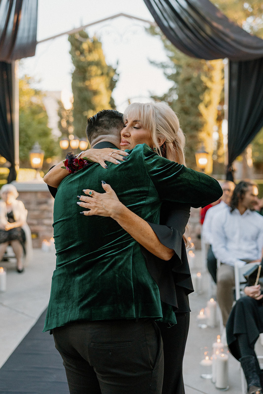 Emotional embrace between groom and family member during the ceremony at a wedding venue in Chandler.