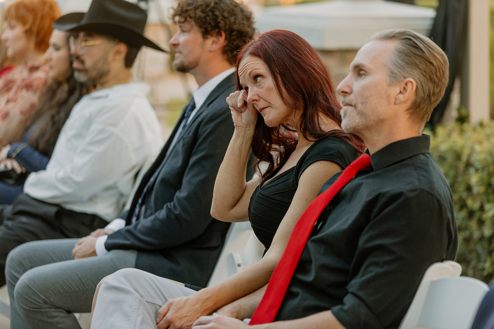 Guest wiping away tears during an outdoor ceremony at this wedding venue in Chandler.