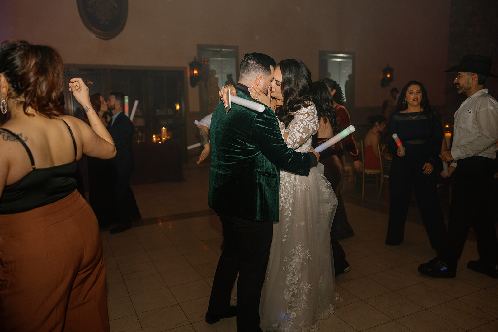Bride and groom kissing on the dance floor during their reception at a wedding venue in Chandler.