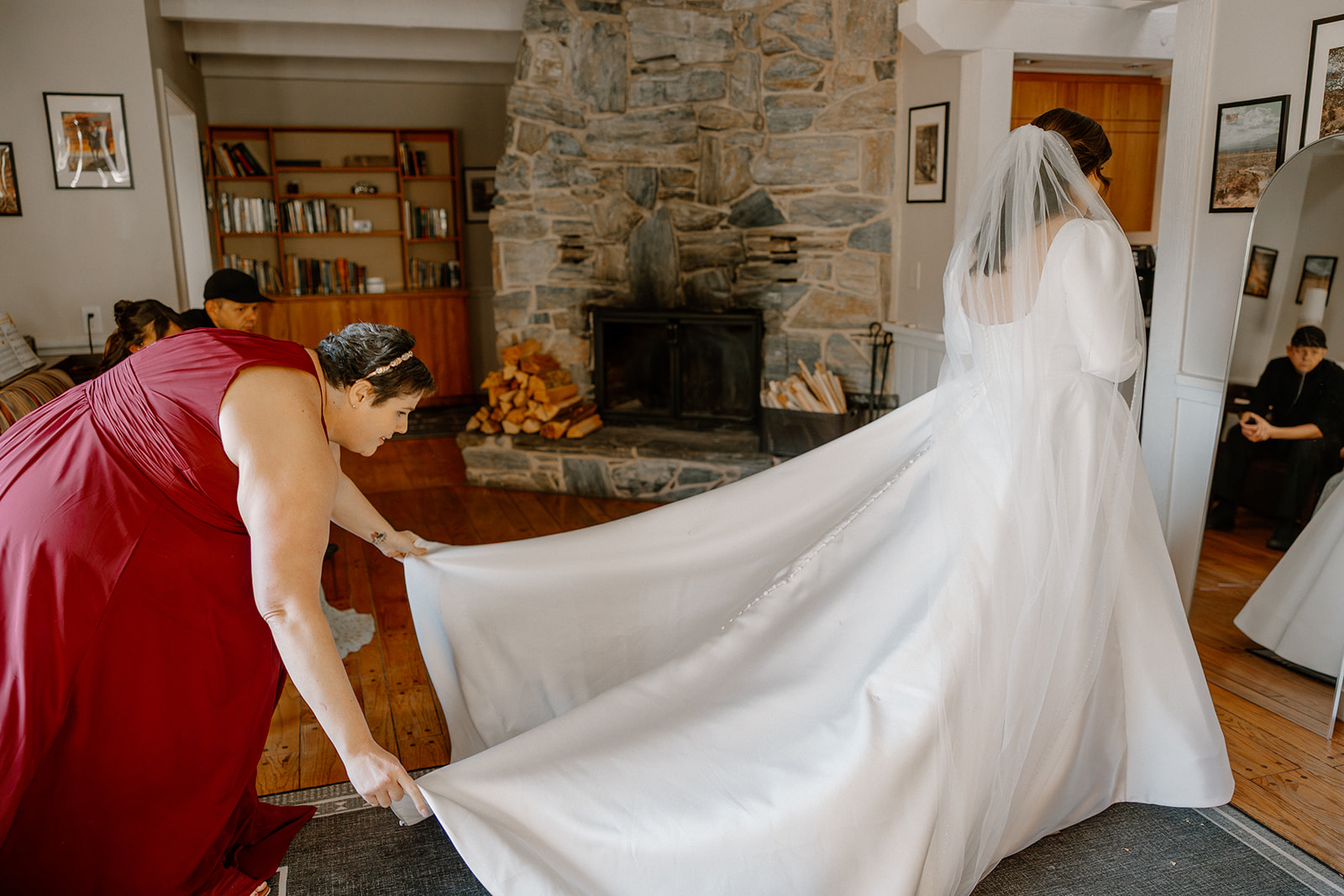 Bride having her dress train adjusted inside a cozy cabin at a Sedona wedding venue
