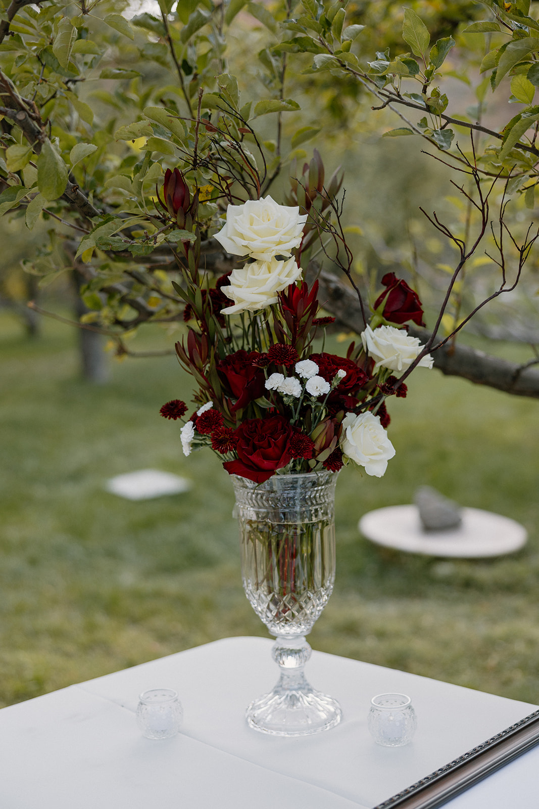 Floral arrangement with red and white flowers displayed outdoors at Orchard Canyon on Oak Creek