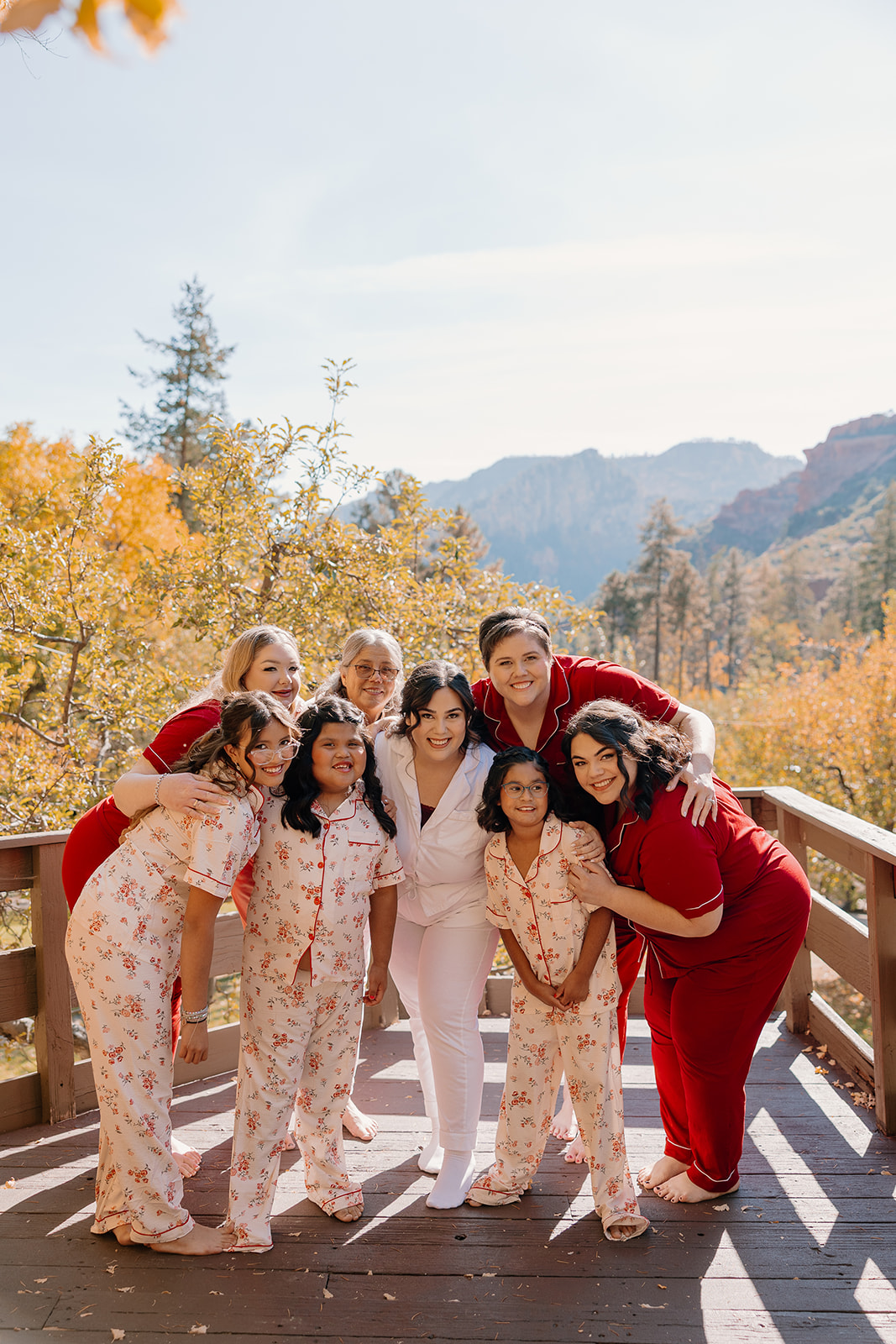 Bride surrounded by family and friends in matching pajamas before the wedding