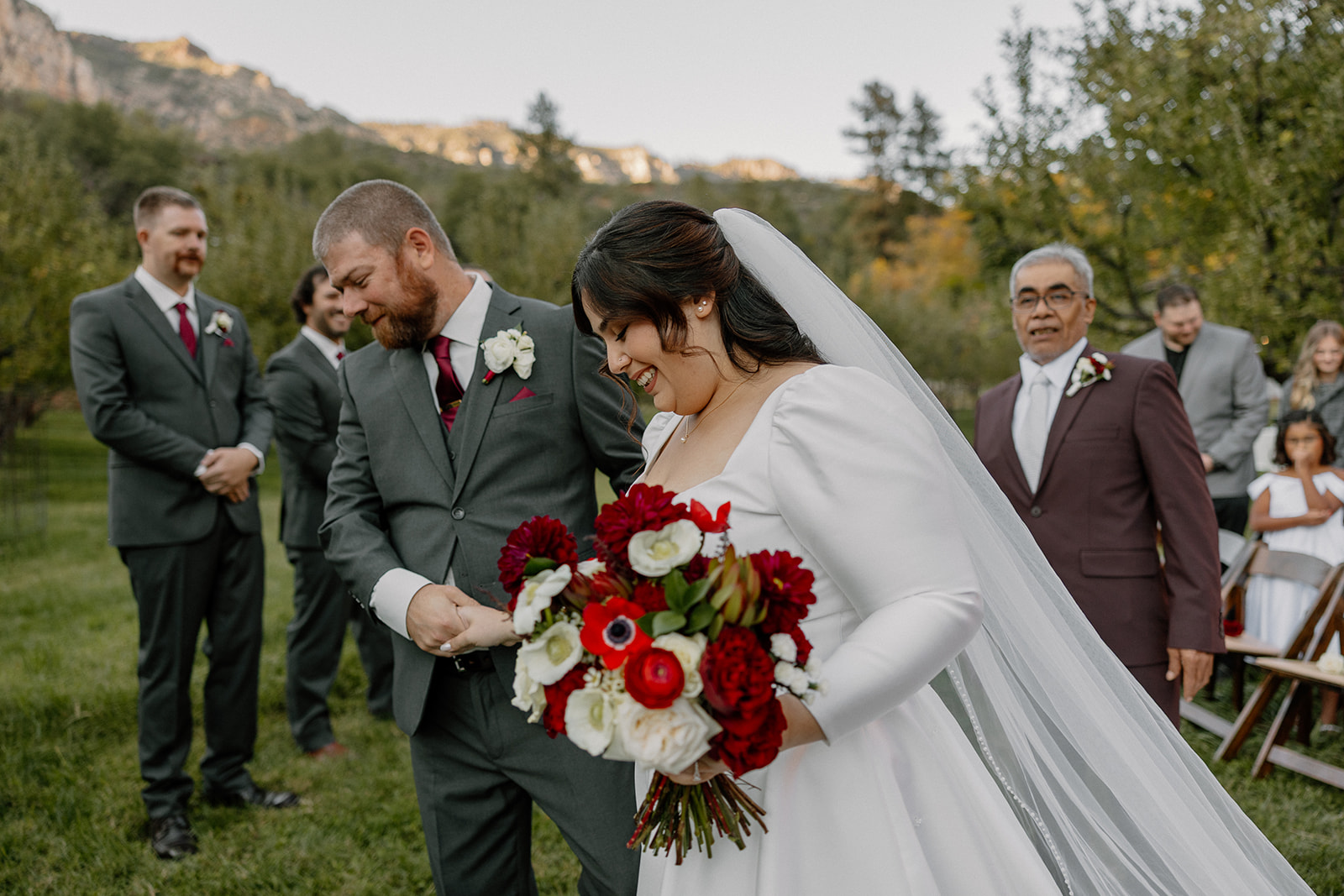 Bride and groom walking back down the aisle together after their ceremony
