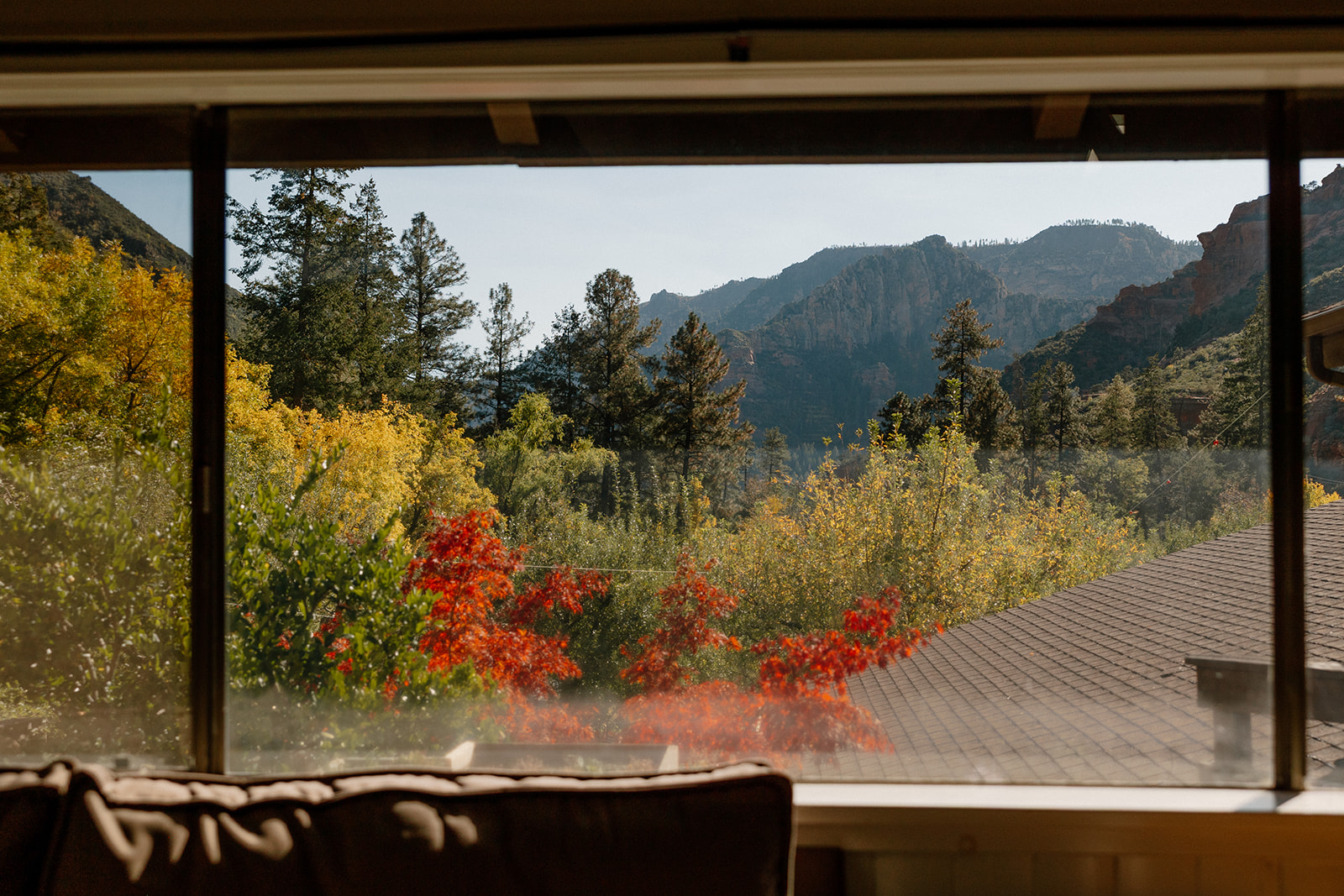Mountain and orchard views seen through a window at a Sedona wedding venue