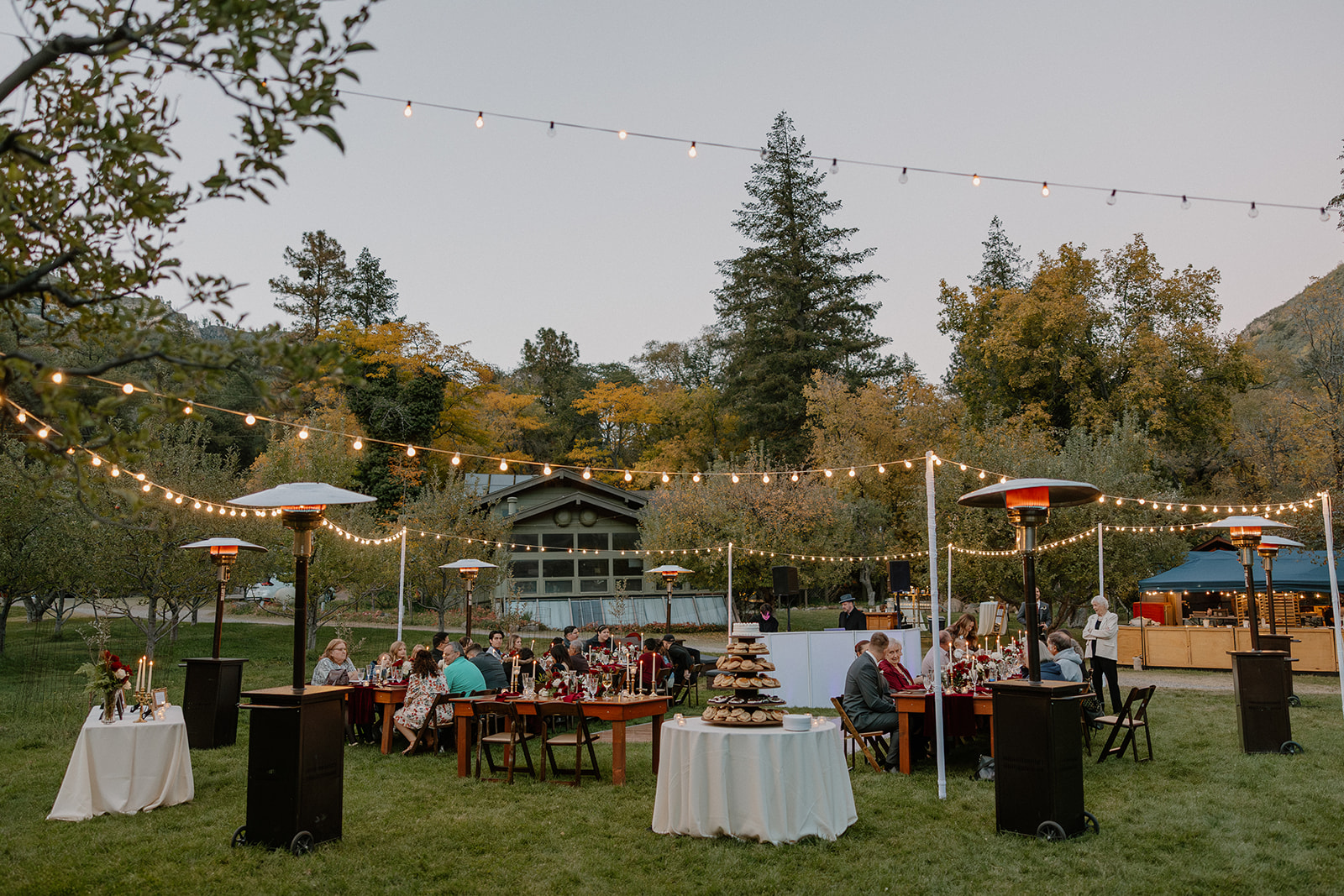 Evening reception at a Sedona wedding venue with string lights, heaters, and guests dining outdoors