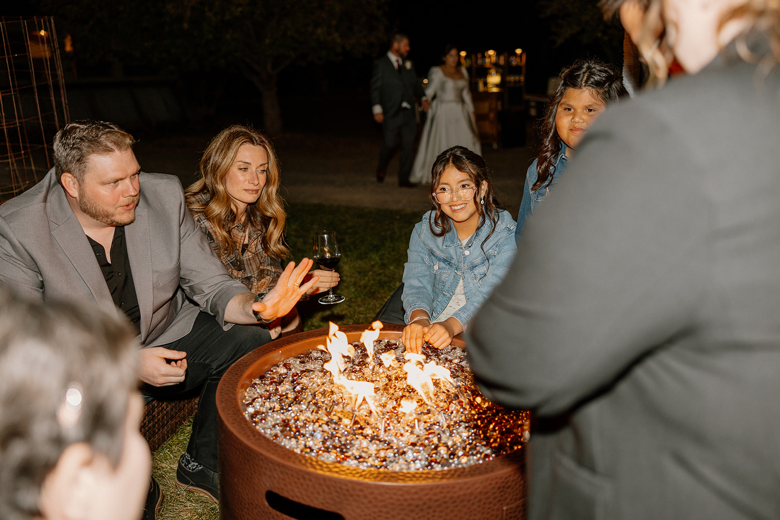 Guests gathered around a fire pit during an evening celebration at a Sedona wedding venue