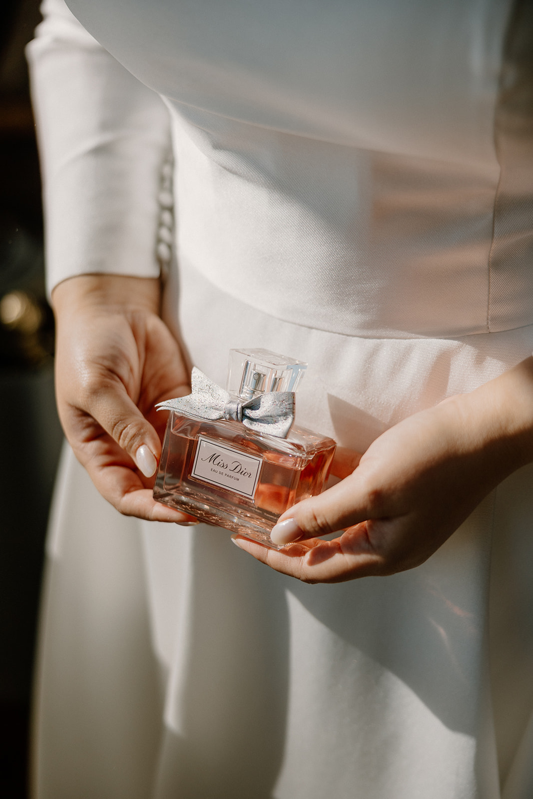 Bride holding her wedding perfume during final getting ready moments at a Sedona wedding venue