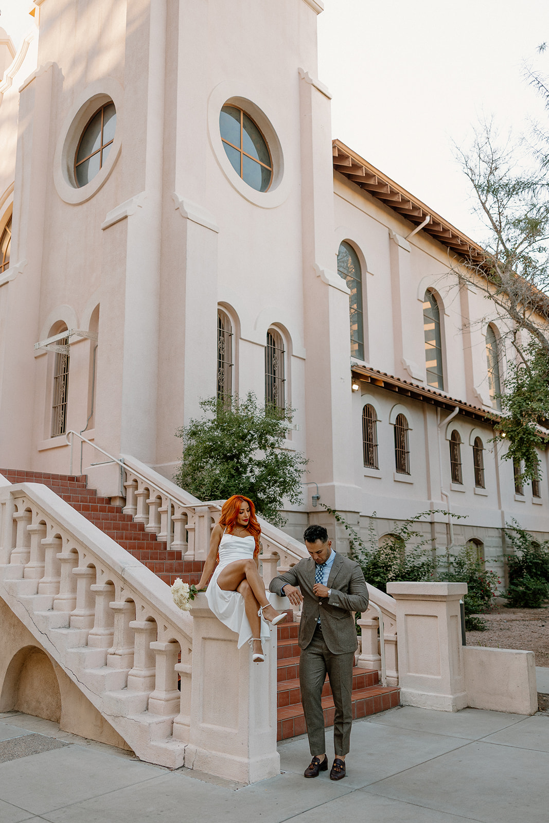 Couple posing near historic staircase and architecture in downtown Phoenix engagement session
