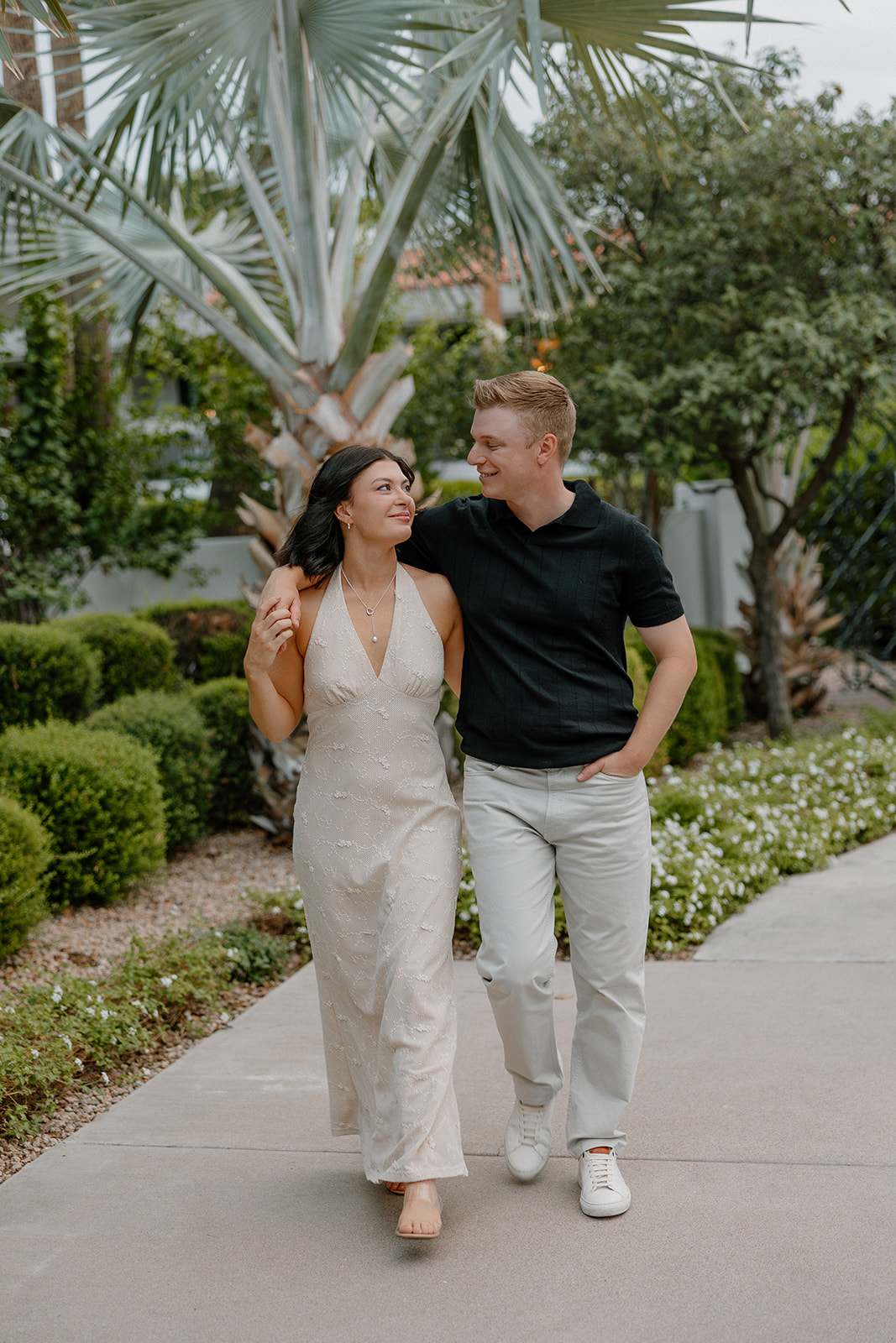 Couple walking together under palm trees at a Scottsdale resort
