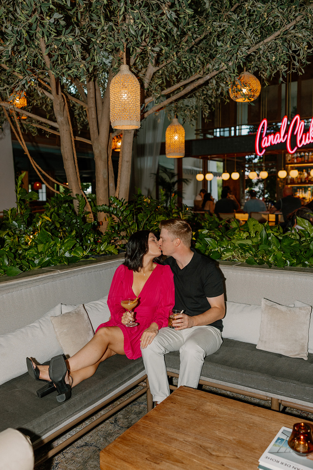 Hotel engagement photos at The Canal Club with couple kissing on a couch

