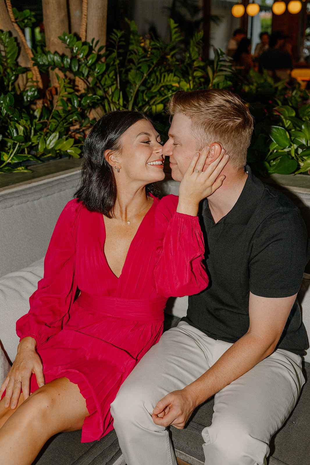 Close-up of couple smiling together during an intimate engagement moment
