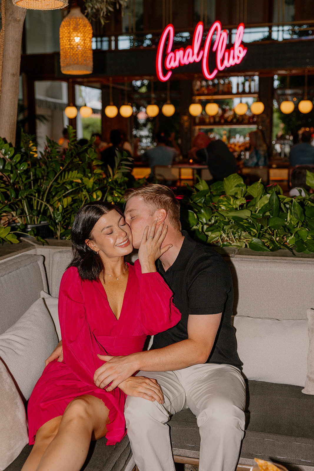 Hotel engagement photos at The Canal Club with couple sitting together on a couch
