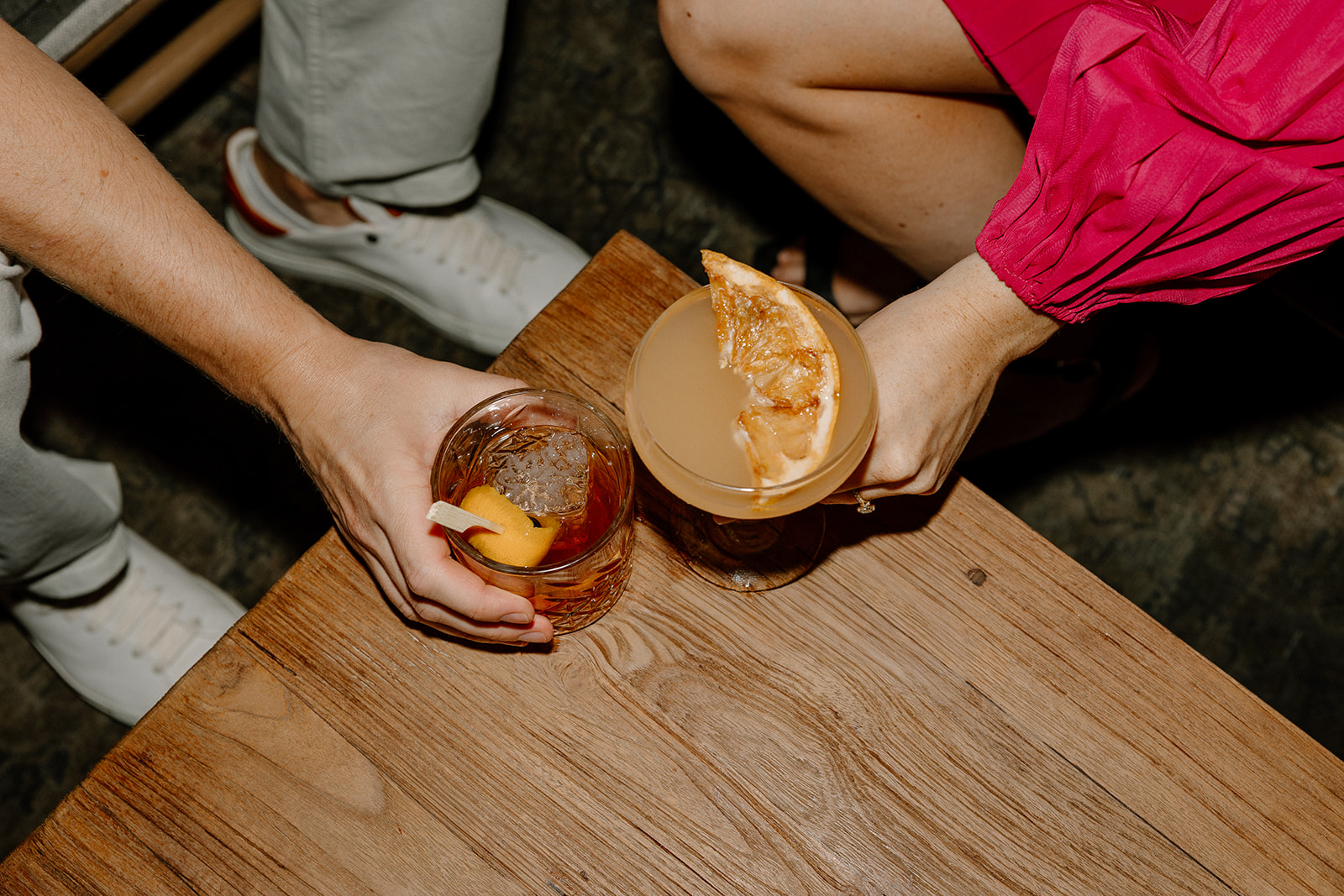Close-up of cocktails on a table during a relaxed date-night engagement session
