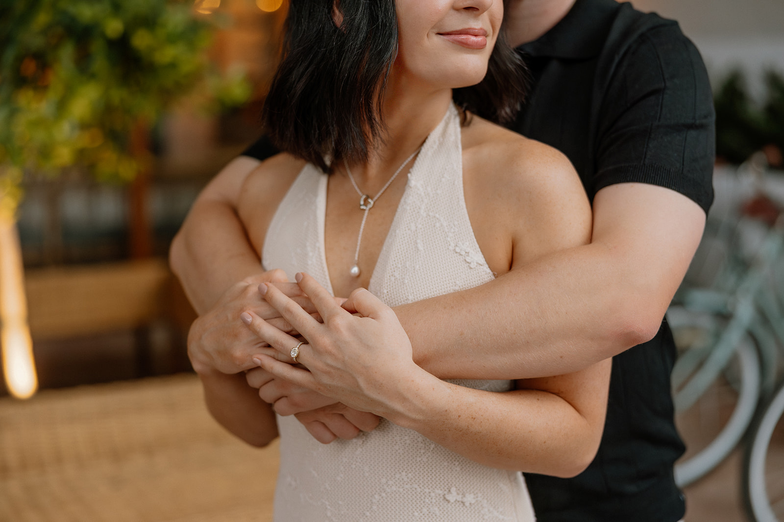 Close-up of engagement ring and hands during a romantic hotel engagement session