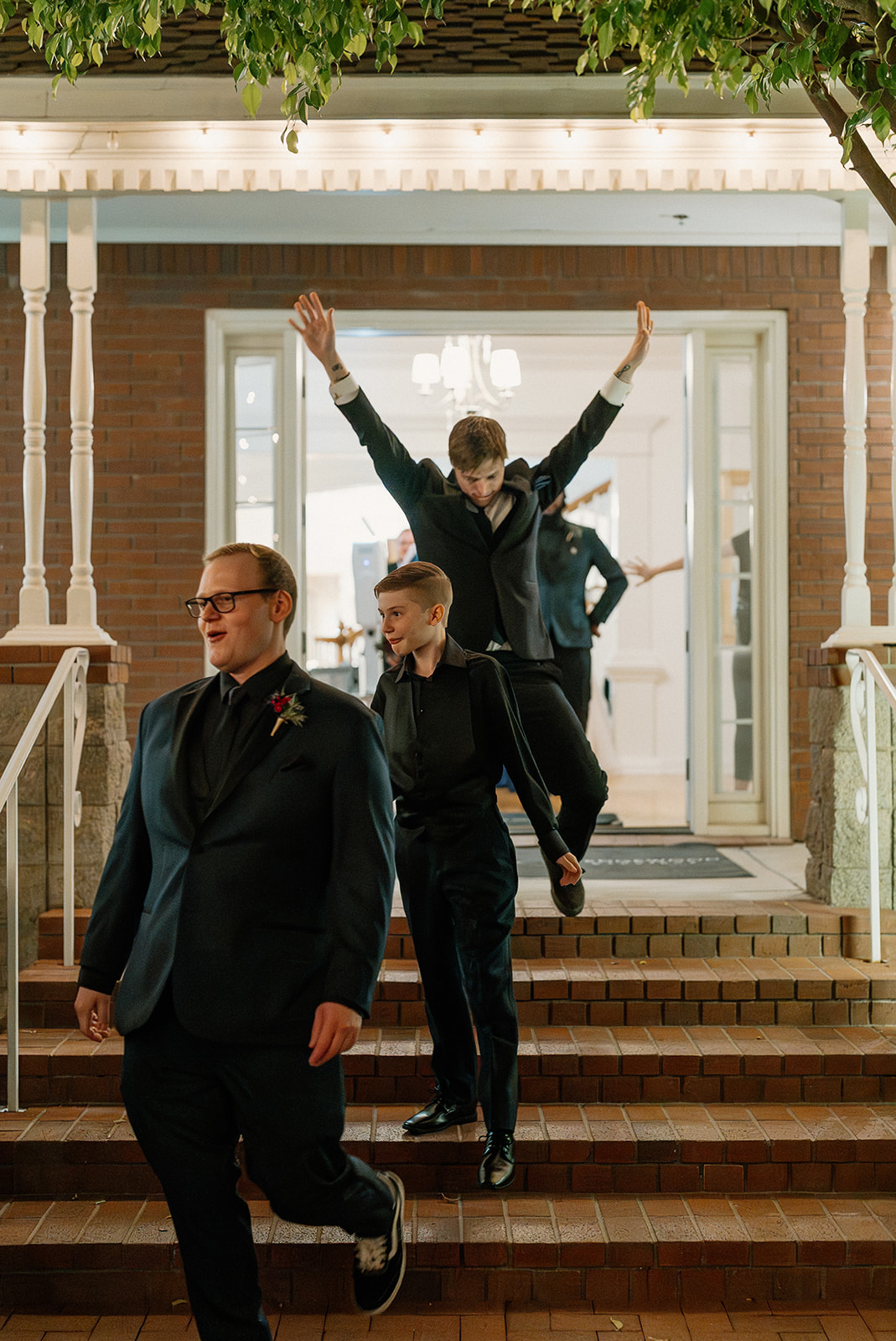 Groomsmen making a fun reception entrance at Stonebridge Manor Wedding Venue