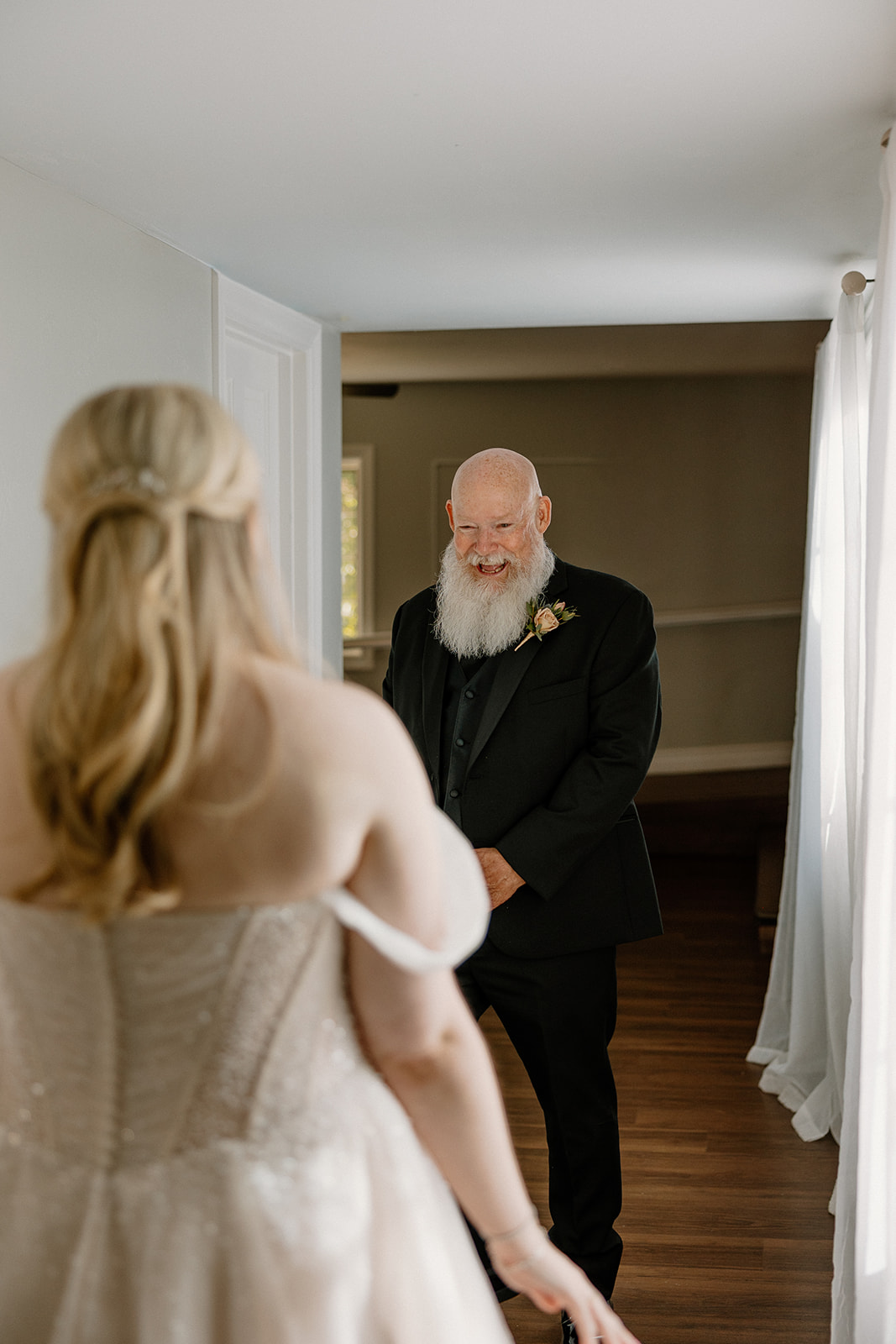 Father smiling during heartfelt first look moment with bride at Stonebridge Manor Wedding Venue