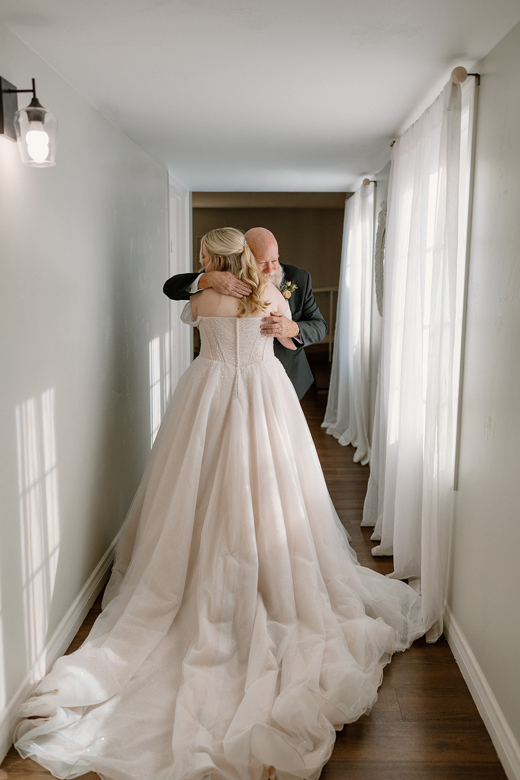 Emotional first look hug between bride and father at Stonebridge Manor Wedding Venue
