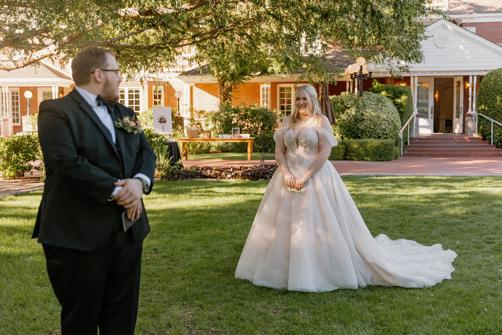 Bride and groom first look moment on the lawn at Stonebridge Manor in Mesa Arizona