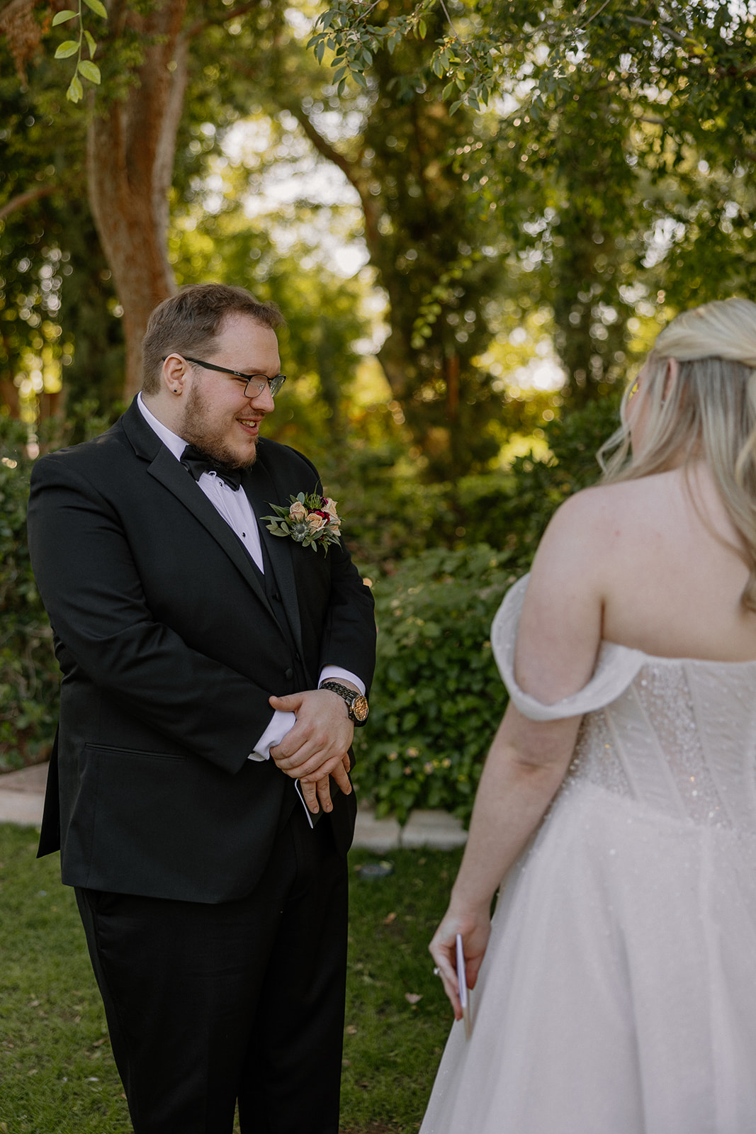Groom reacting during emotional first look with bride at Stonebridge Manor Wedding Venue