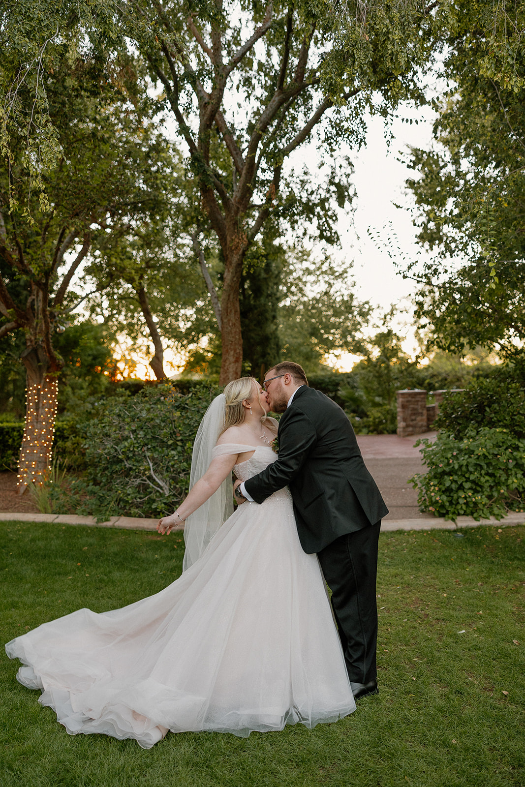 Romantic sunset kiss on the lawn at Stonebridge Manor Wedding Venue