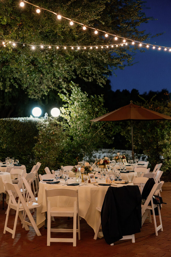 Outdoor reception tables under string lights at Stonebridge Manor Wedding Venue patio