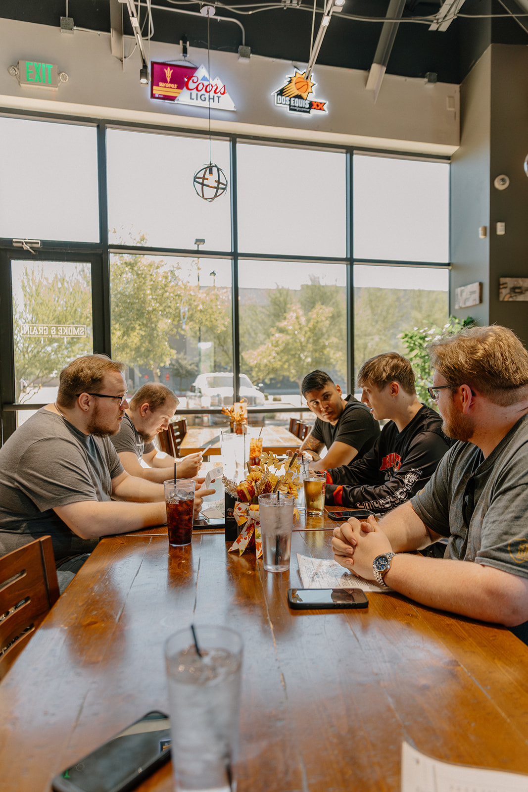 Groom and groomsmen having lunch together before wedding day preparations