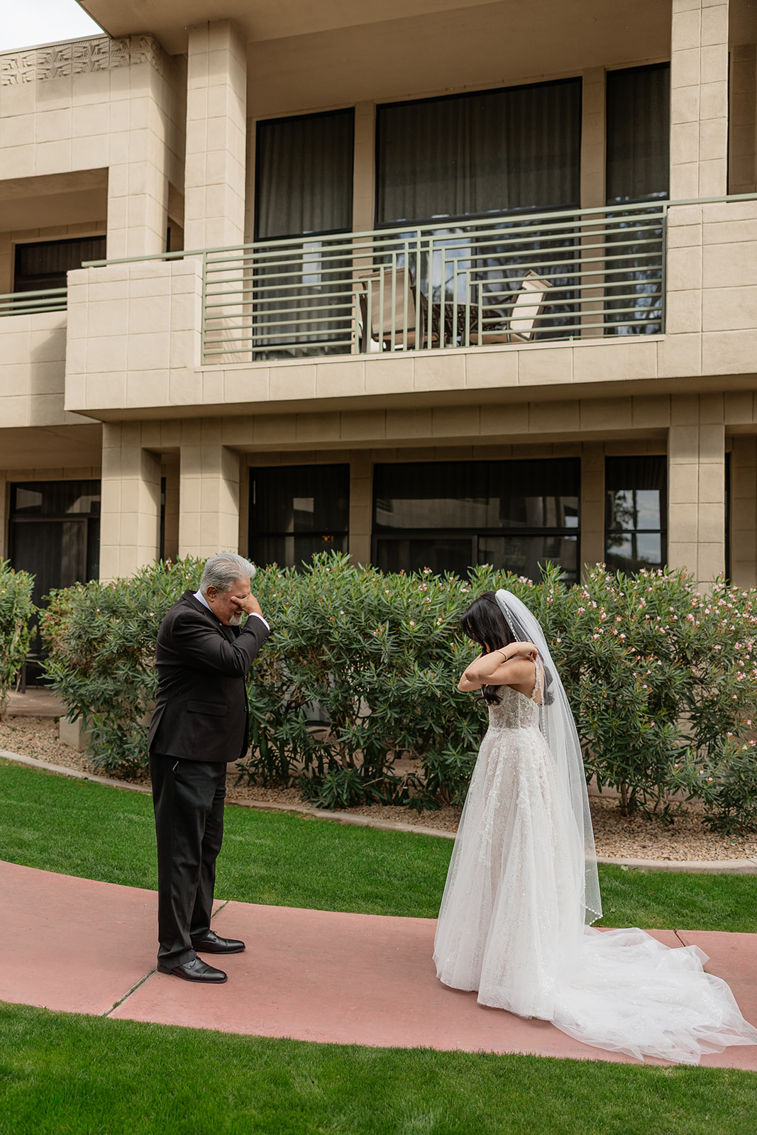 Bride and her father standing apart and wiping away tears during their first look at a Biltmore wedding
