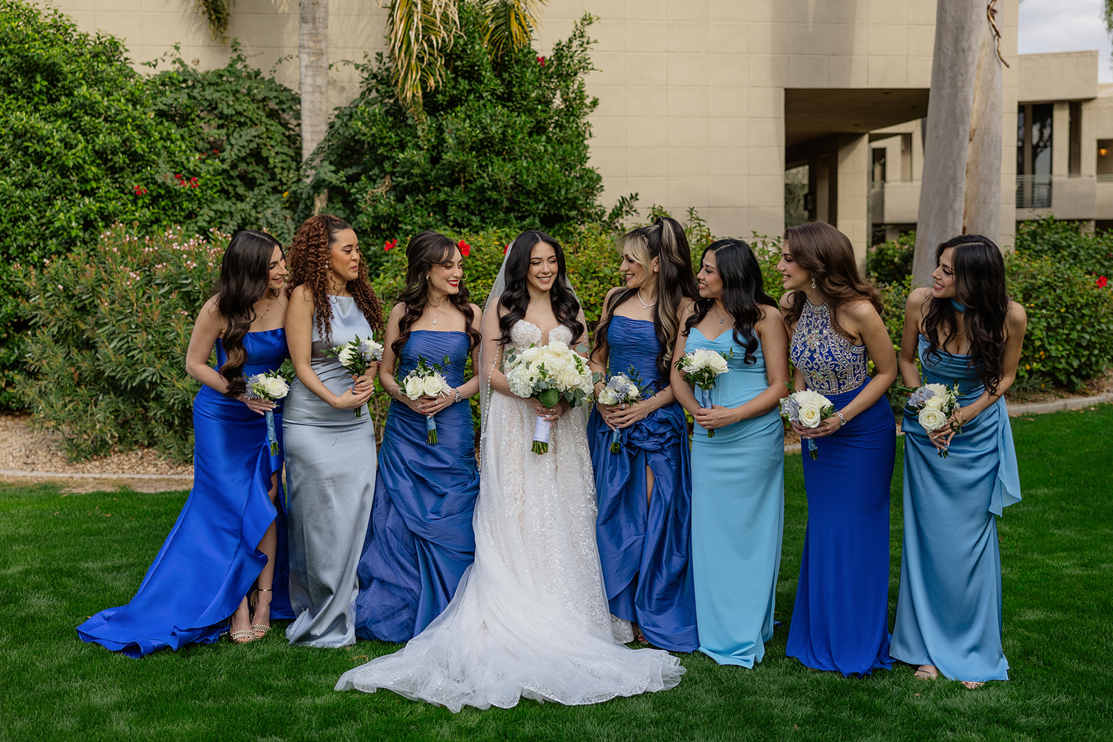 Bride with her bridesmaids in blue dresses standing together on the lawn during a Biltmore wedding
