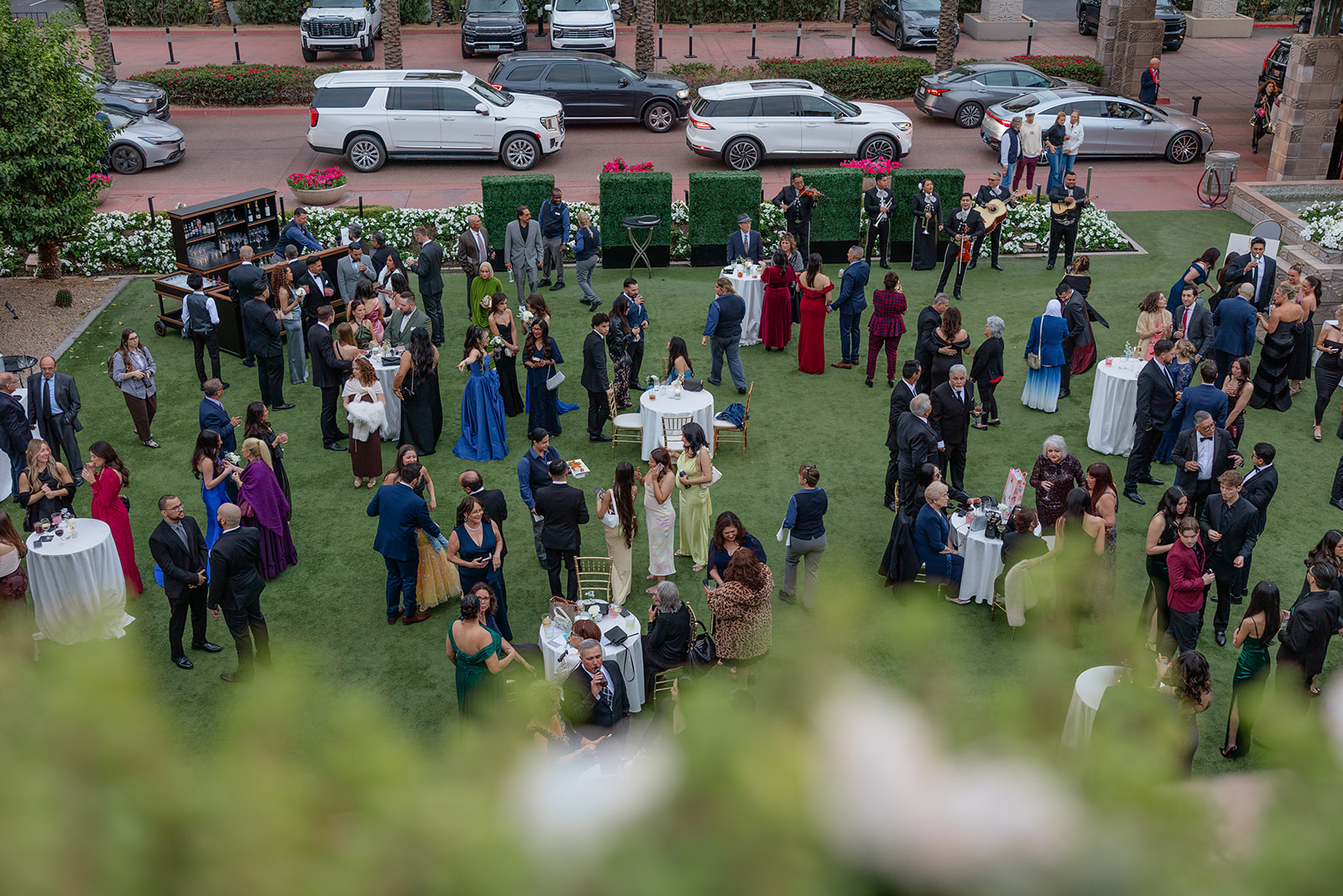 Guests mingling during an outdoor cocktail hour with live music at a Biltmore wedding
