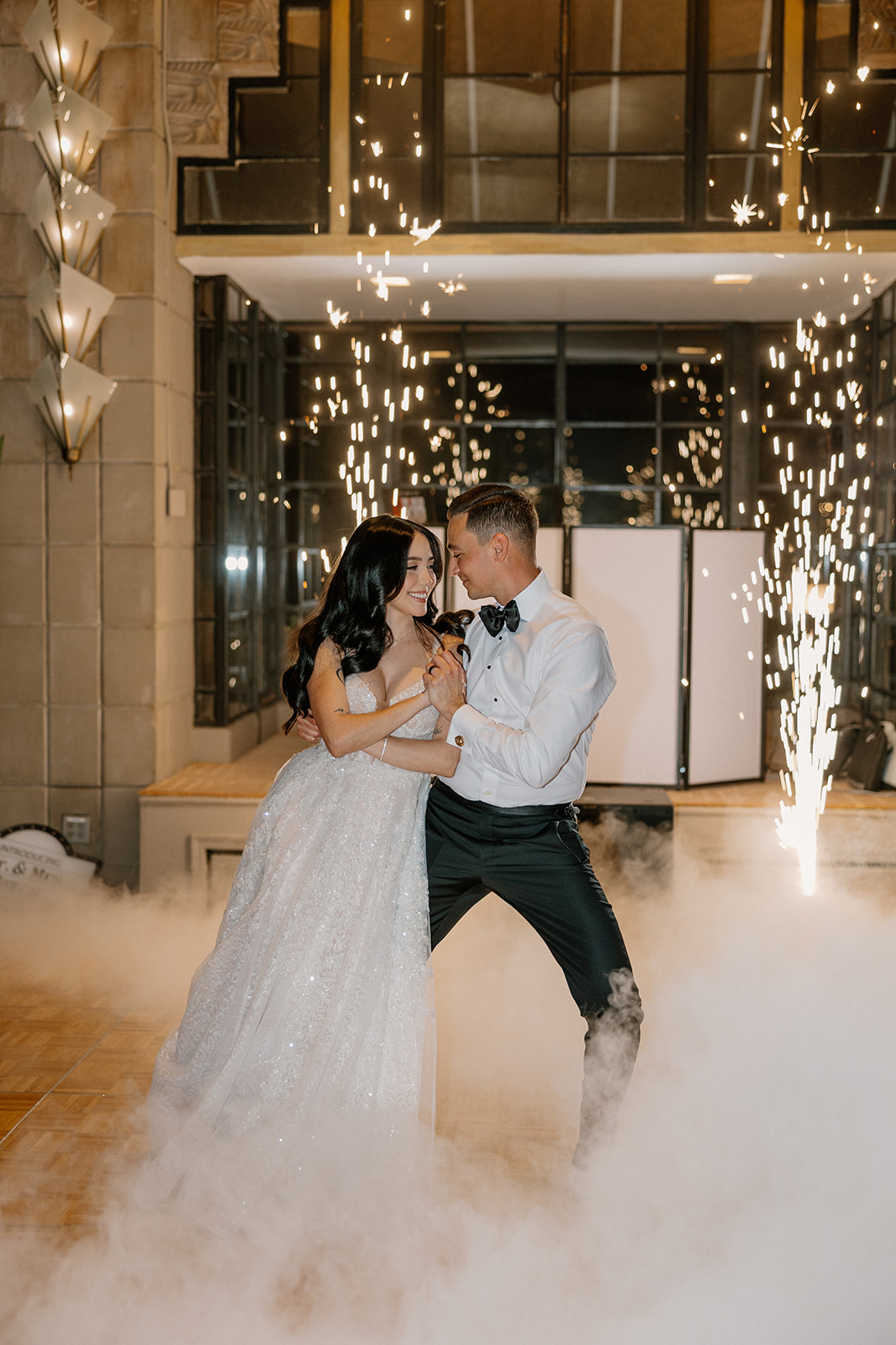 Bride and groom dancing together with indoor sparklers and low fog during their Biltmore wedding reception
